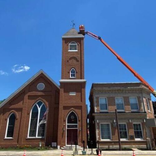 commercial roofing company working on bell tower