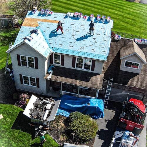residential roofers installing new asphalt roofing on home